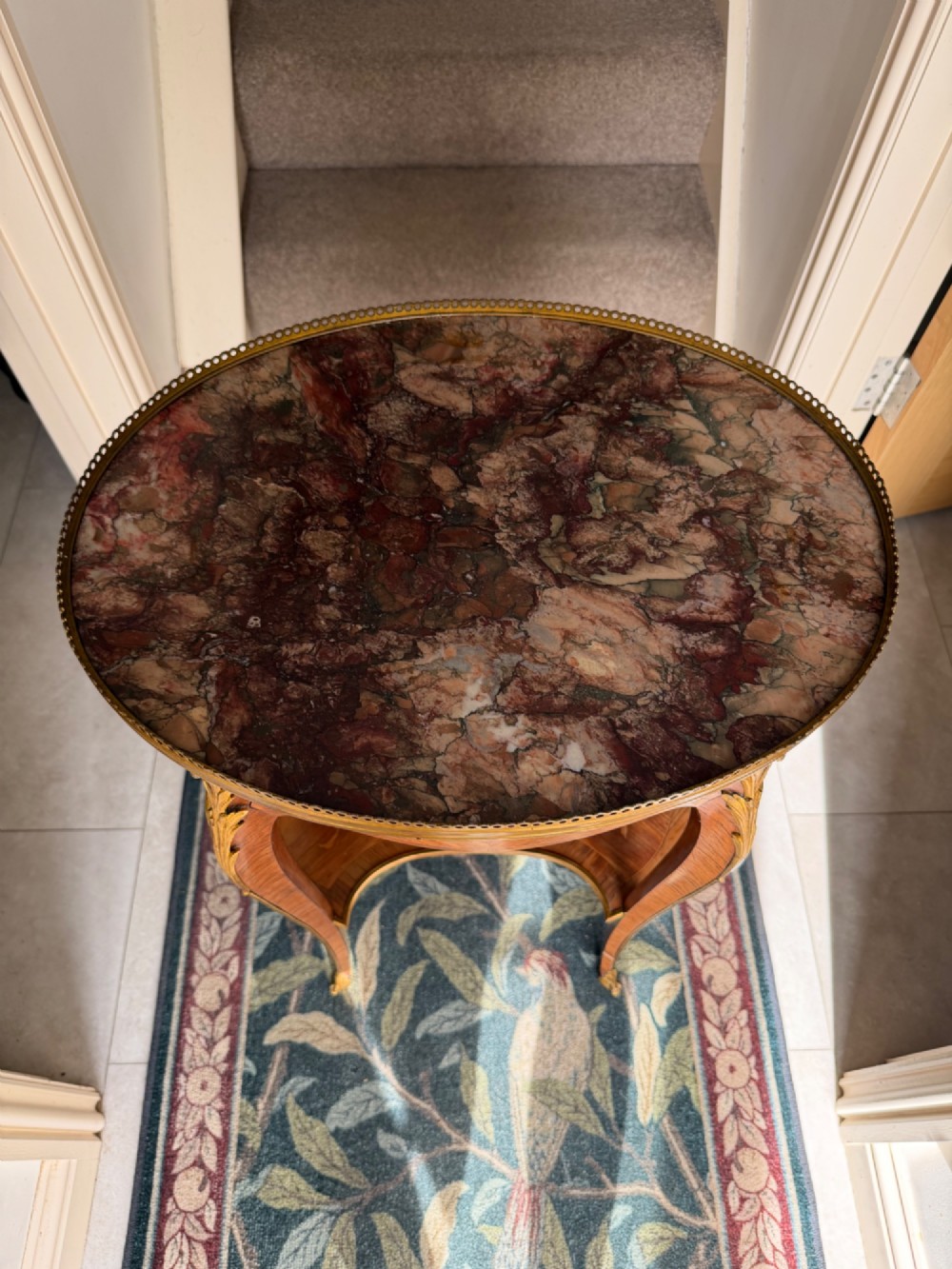An oval French Louis XV style kingwood side table featuring a mottled red marble top, pierced brass gallery, floral marquetry inlay, and cabriole legs with bronze mounts. View VII