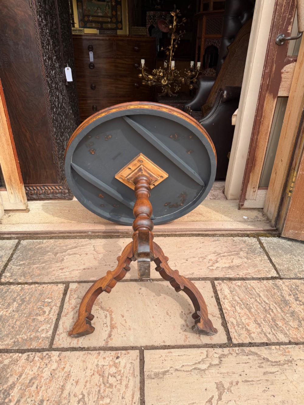 A circular wooden pedestal table featuring elaborate geometric starburst and floral vine marquetry inlays supported by a turned central column and carved tripod legs. View III