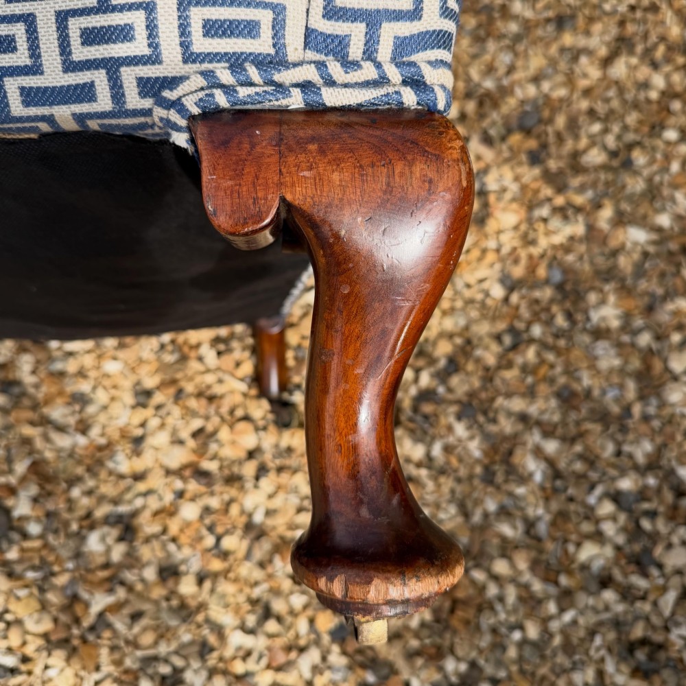 A pair of high-backed wingback armchairs upholstered in blue and grey geometric patterned fabric with carved dark timber cabriole legs. View II