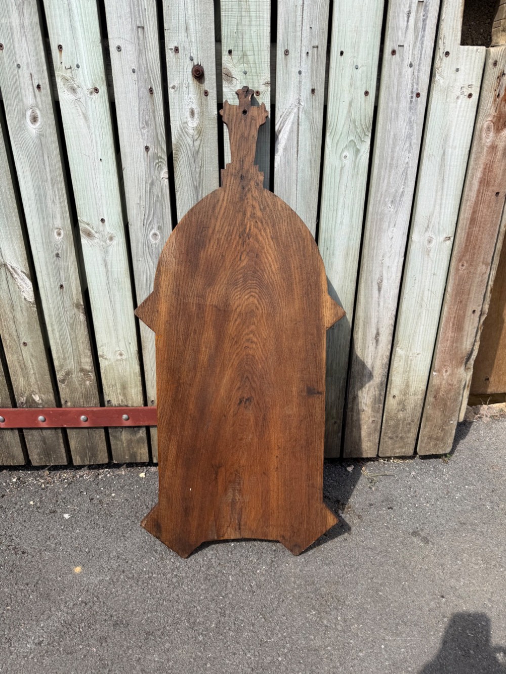 A vertical carved dark oak plaque shaped like a Gothic arch with a cross finial, featuring relief-carved lettering of the Lords Prayer. View IV