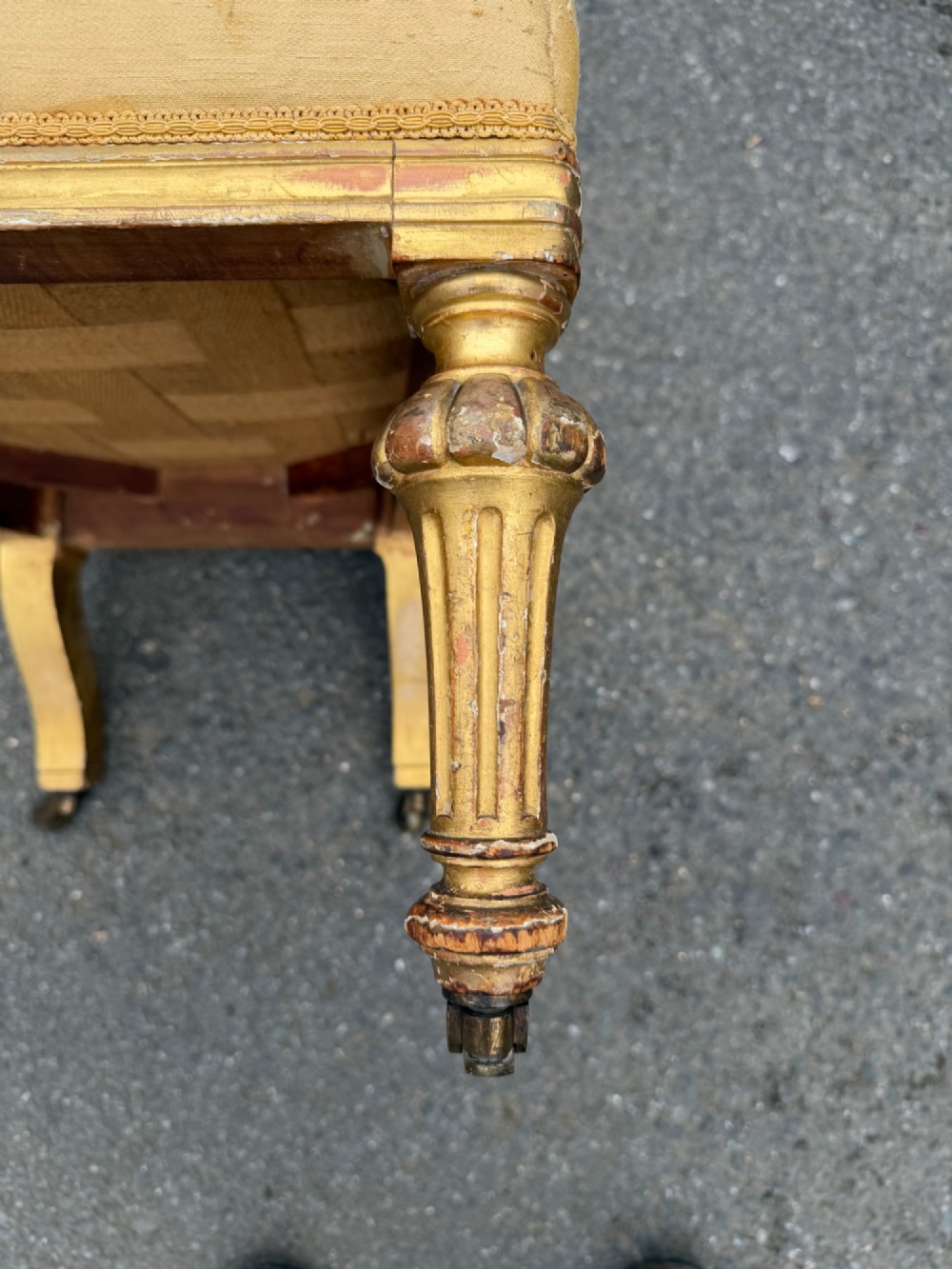 A nineteenth-century prie dieu chair featuring floral needlepoint upholstery, a low seat, a tall T-shaped backrest, and fluted giltwood legs on brass castors. View IV