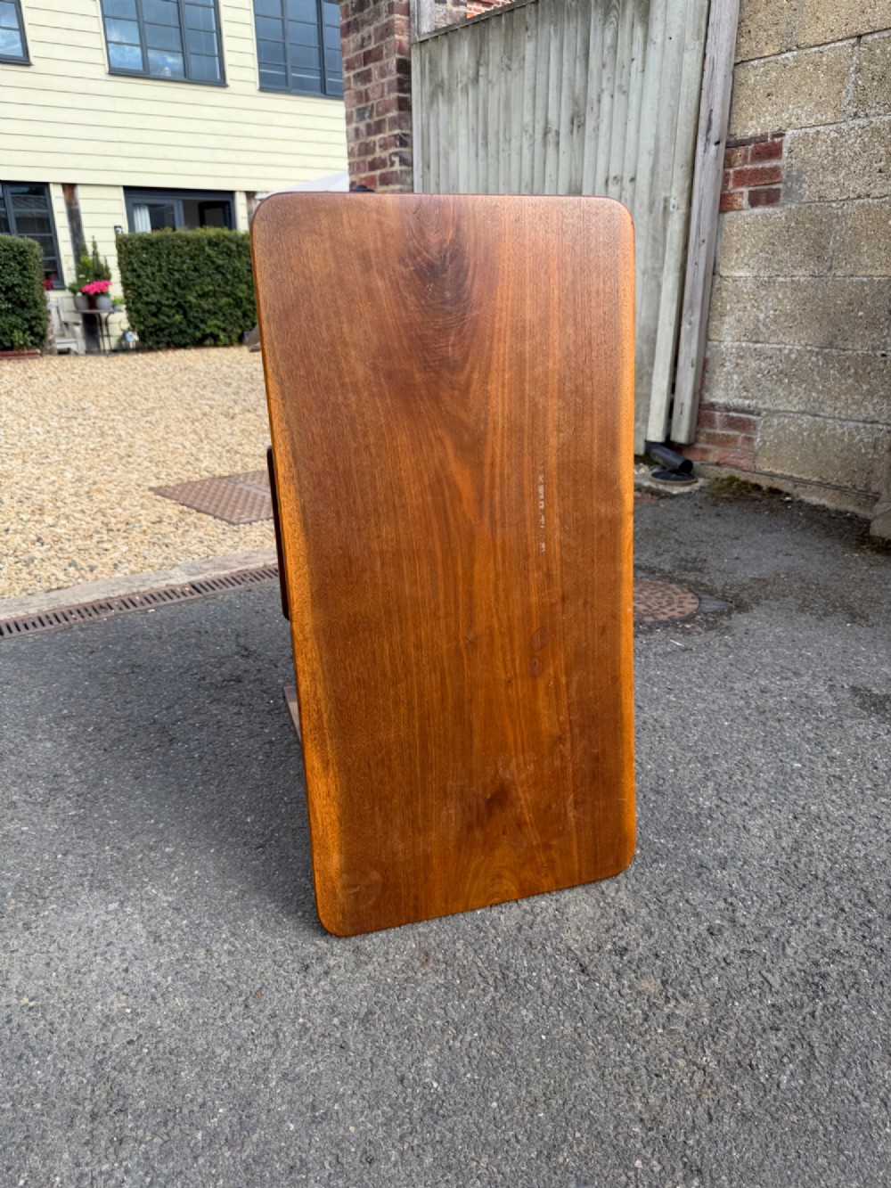 An Anglo-Japanese walnut occasional table featuring a rectangular top, an openwork fretwork frieze, and asymmetrical staggered lower shelves supported by turned spindles. View IV
