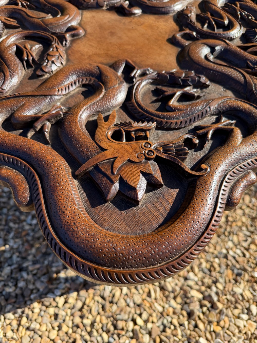 A hand-carved dark walnut side table featuring relief-carved dragon motifs across a lobed top and pierced decorative legs. View II