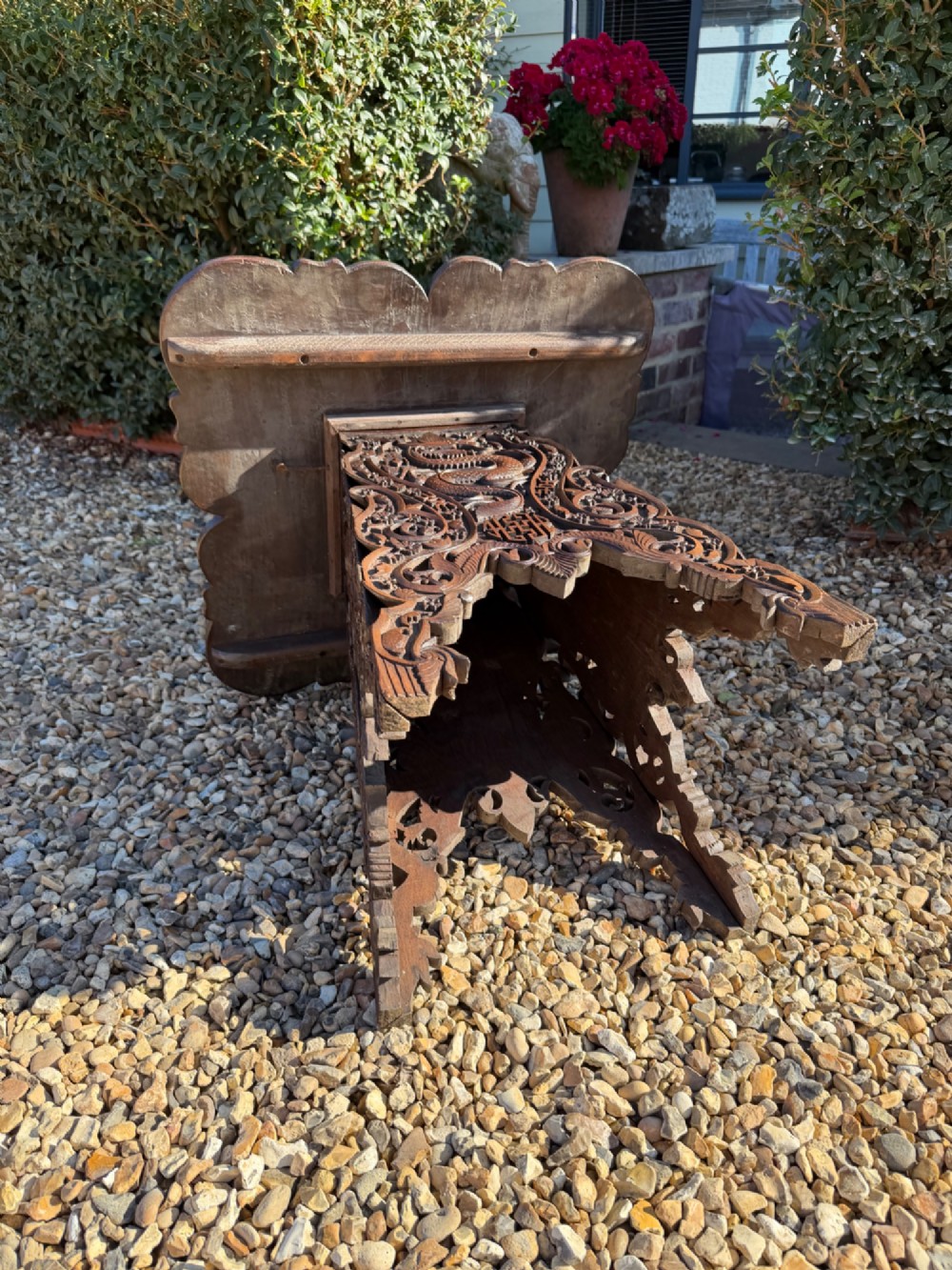 A hand-carved dark walnut side table featuring relief-carved dragon motifs across a lobed top and pierced decorative legs. View V