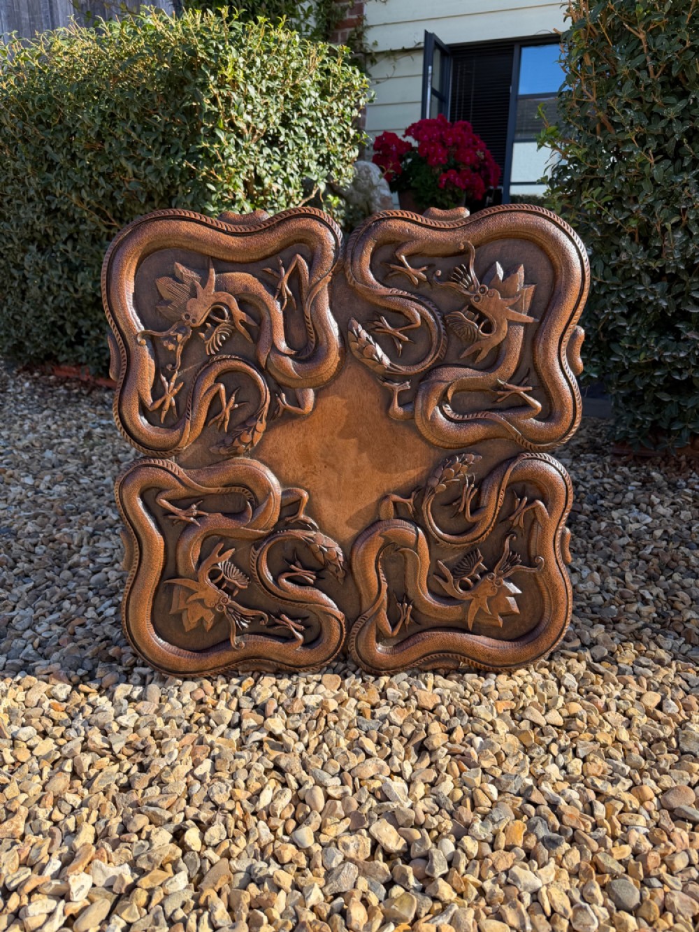 A hand-carved dark walnut side table featuring relief-carved dragon motifs across a lobed top and pierced decorative legs. View VI