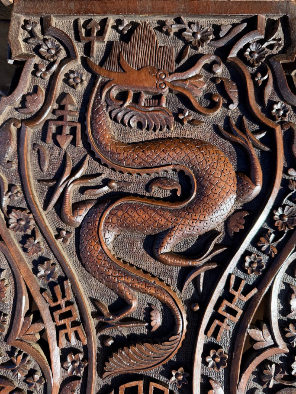 A hand-carved dark walnut side table featuring relief-carved dragon motifs across a lobed top and pierced decorative legs. View VII
