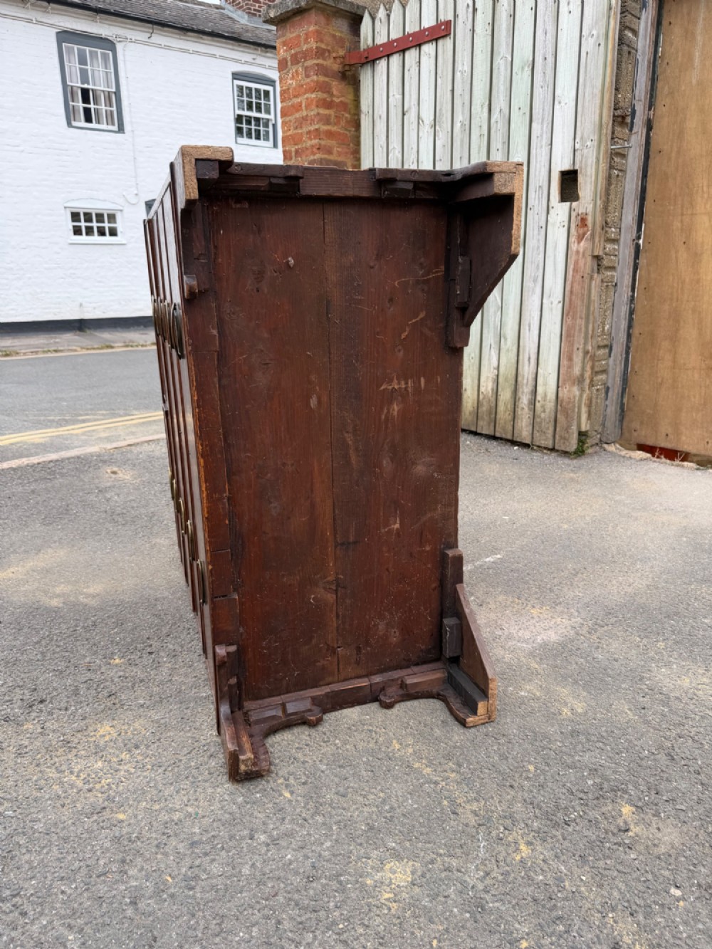 A Georgian oak chest of drawers featuring two short over three long graduated drawers with brass oval handles and bracket feet. View VI