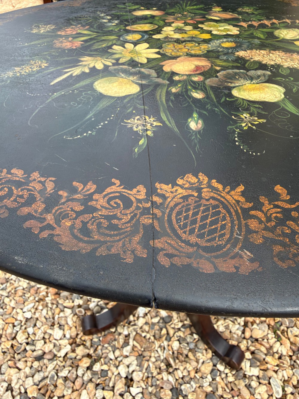 A nineteenth-century circular side table featuring a black slate top decorated with hand-painted botanical flowers and a gilt border, raised on a fluted dark wood pedestal stem with tripod legs. View II