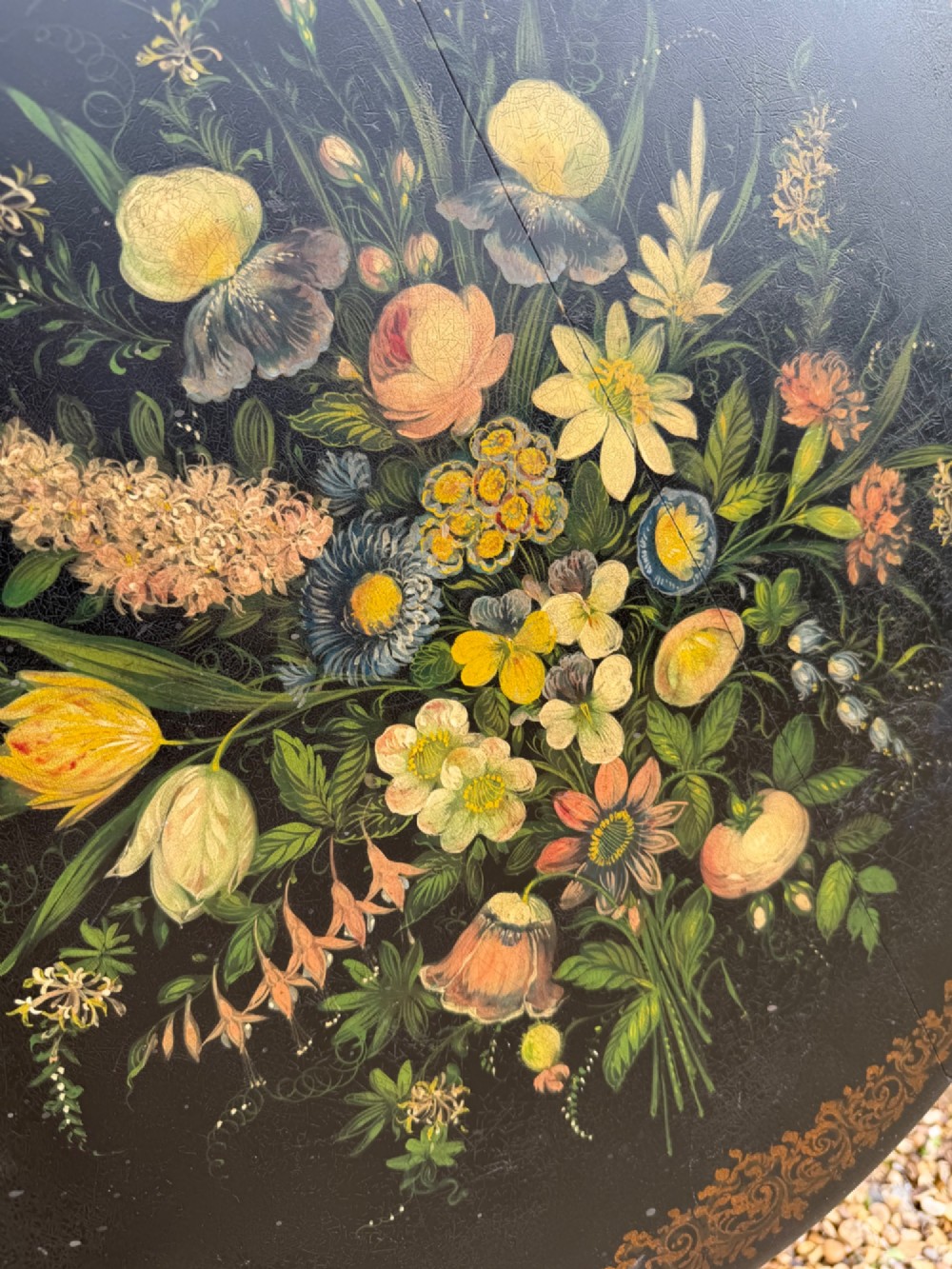 A nineteenth-century circular side table featuring a black slate top decorated with hand-painted botanical flowers and a gilt border, raised on a fluted dark wood pedestal stem with tripod legs. View IV