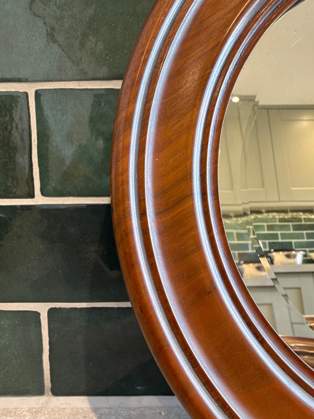 A pair of circular mirrors set in deep moulded warm brown walnut wood frames. View III