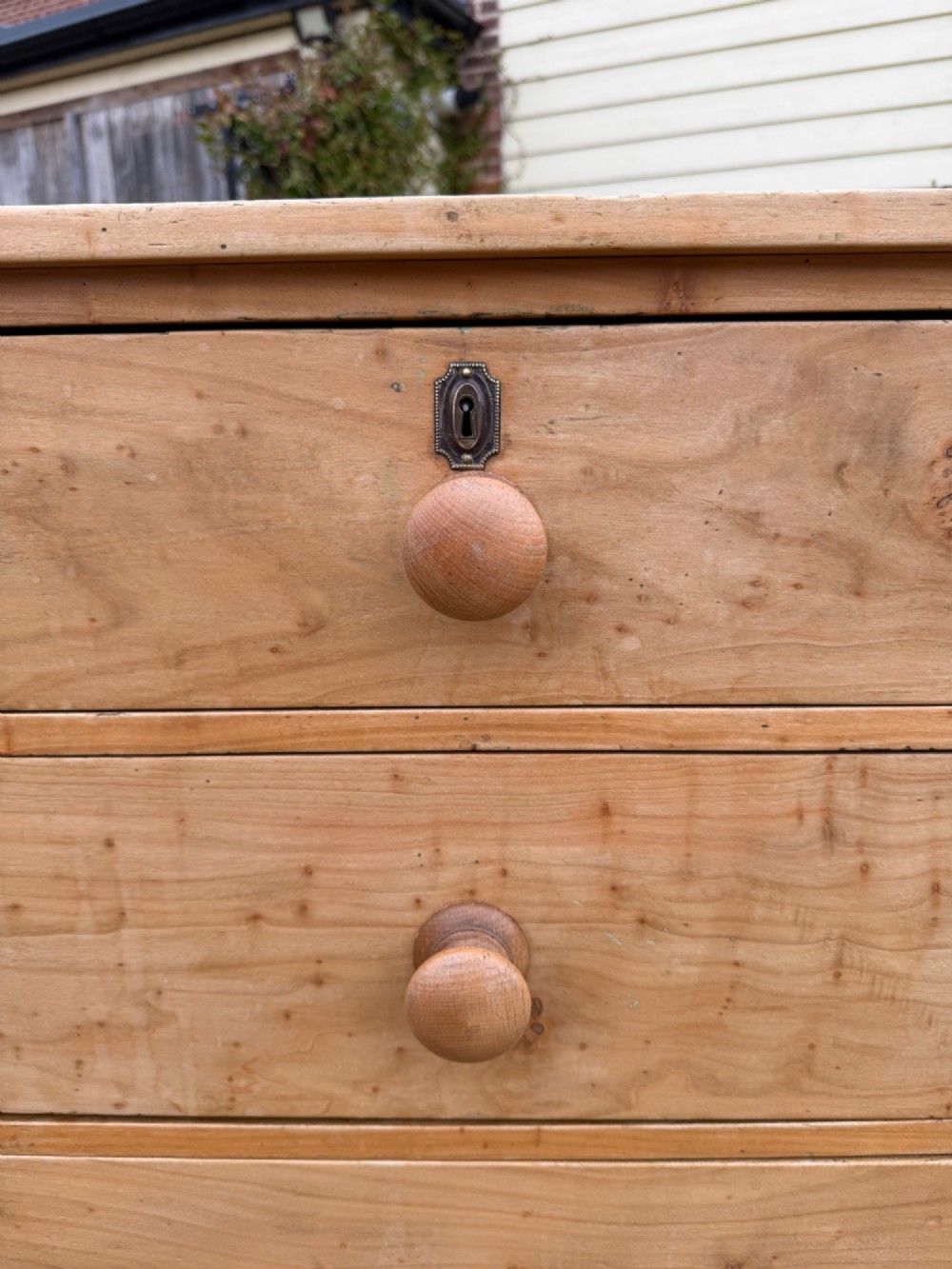 A nineteenth-century light maple chest of drawers featuring a two-over-three drawer arrangement, turned wooden handles, and bracket feet. View II