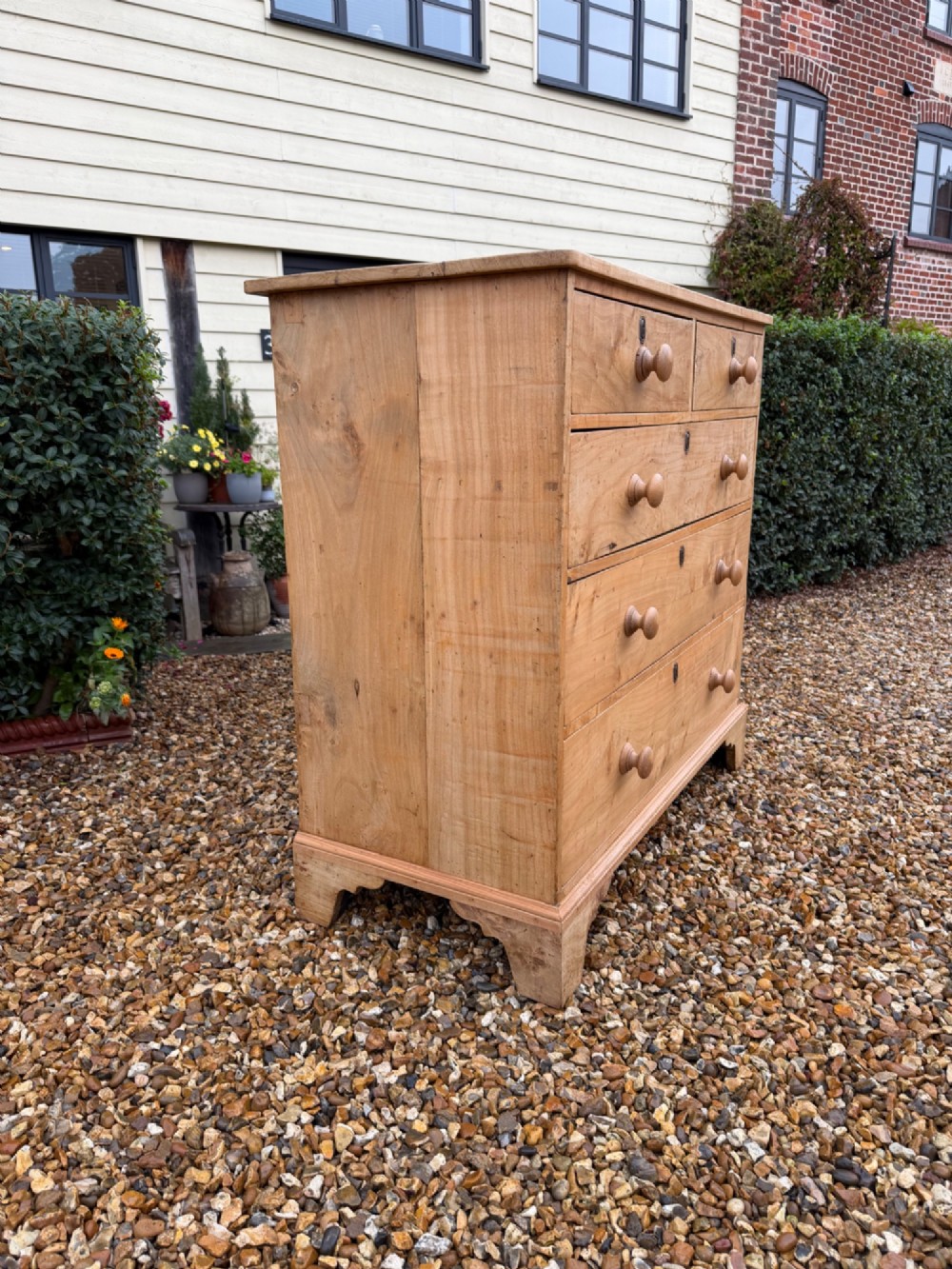 A nineteenth-century light maple chest of drawers featuring a two-over-three drawer arrangement, turned wooden handles, and bracket feet. View IV