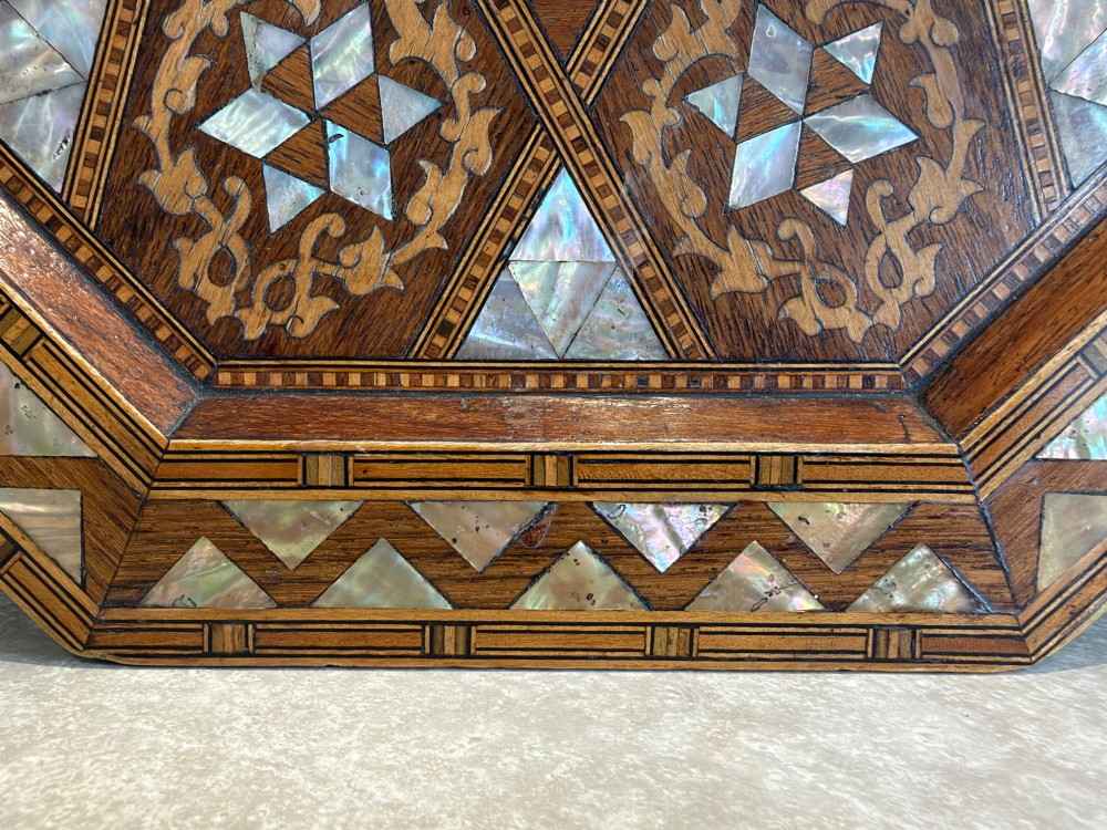 An octagonal wooden side table with intricate Moorish geometric marquetry, mother-of-pearl inlay, and Arabic calligraphy in the central medallion. View III