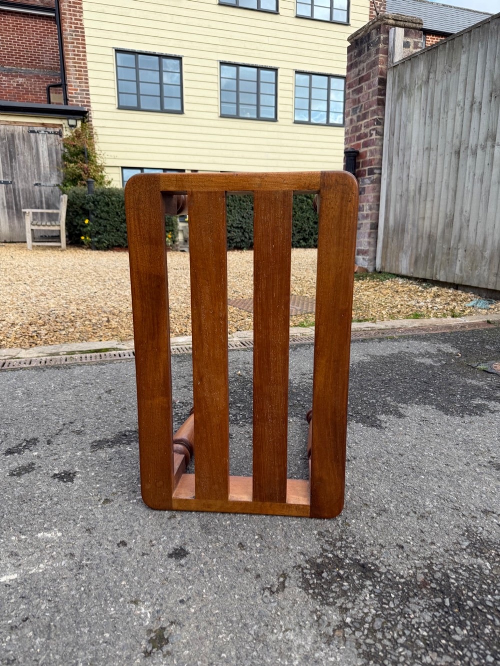 A Victorian warm brown timber luggage rack featuring a slatted wooden top supported by four turned legs. View III