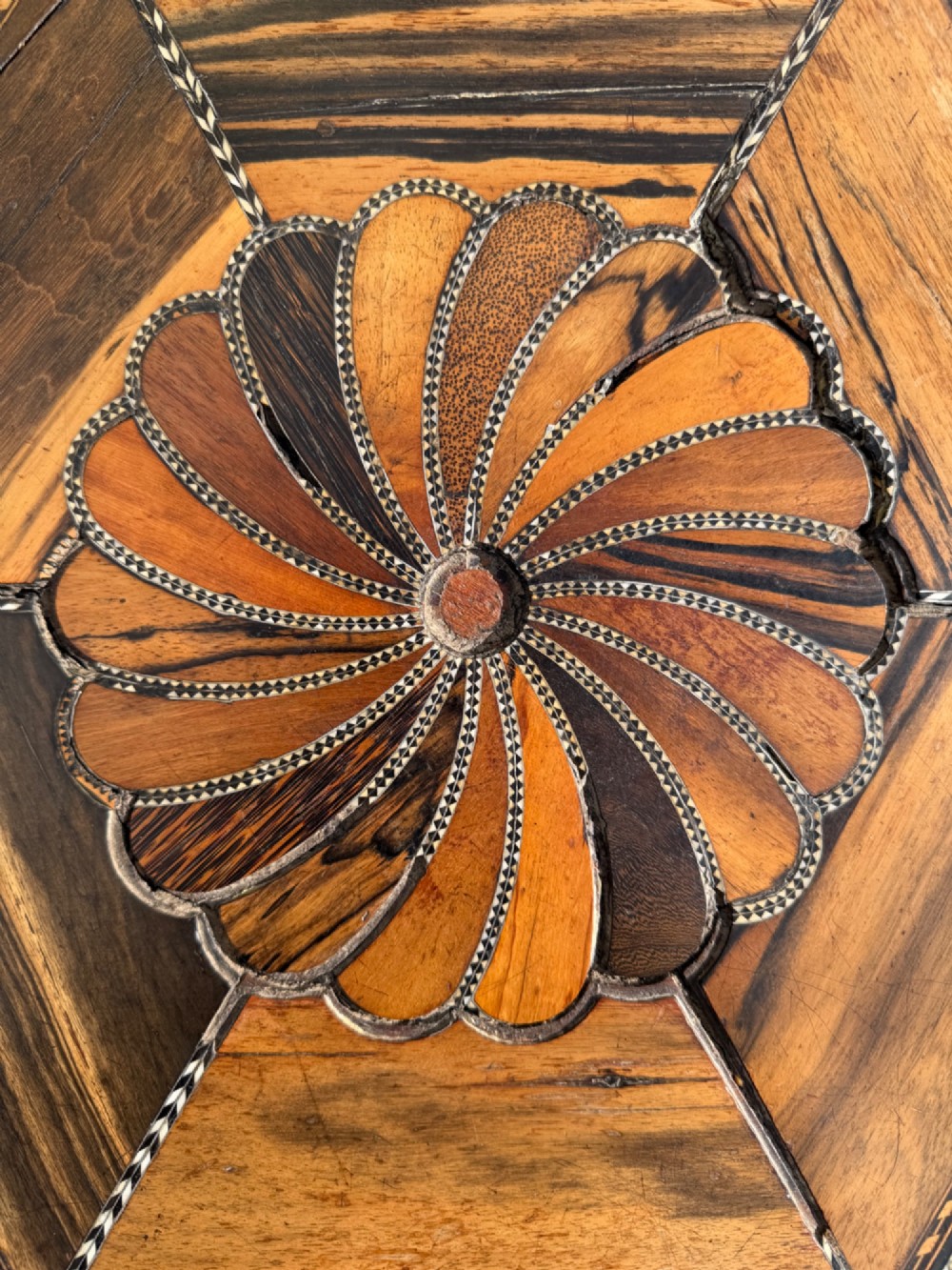 A pair of 19th-century Ceylonese ebony hexagonal occasional tables featuring inlaid geometric specimen wood tops and carved scroll legs. View III