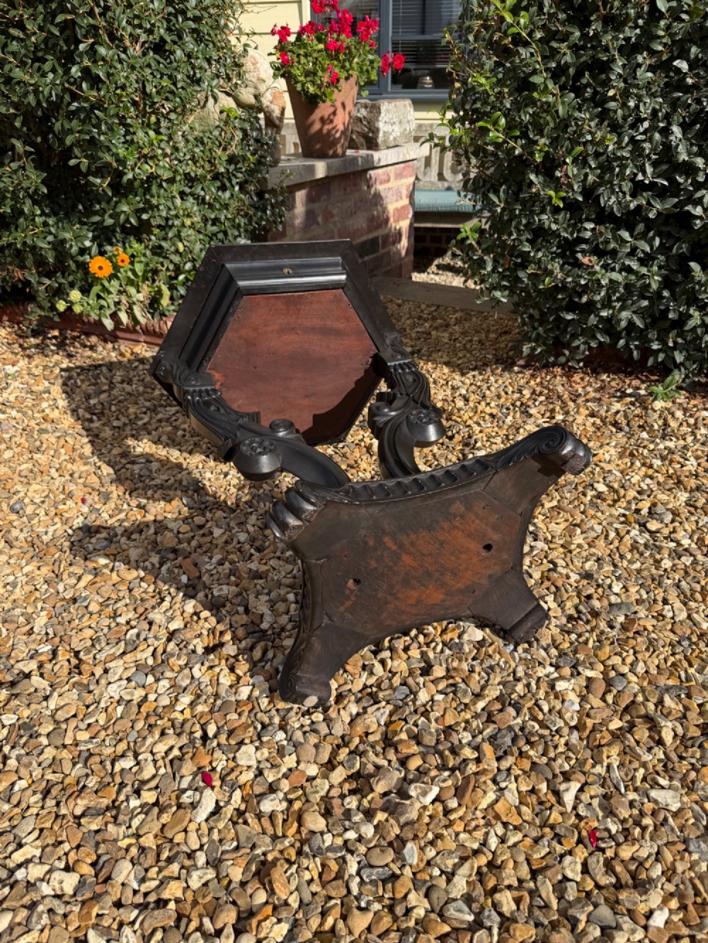 A pair of 19th-century Ceylonese ebony hexagonal occasional tables featuring inlaid geometric specimen wood tops and carved scroll legs. View IV