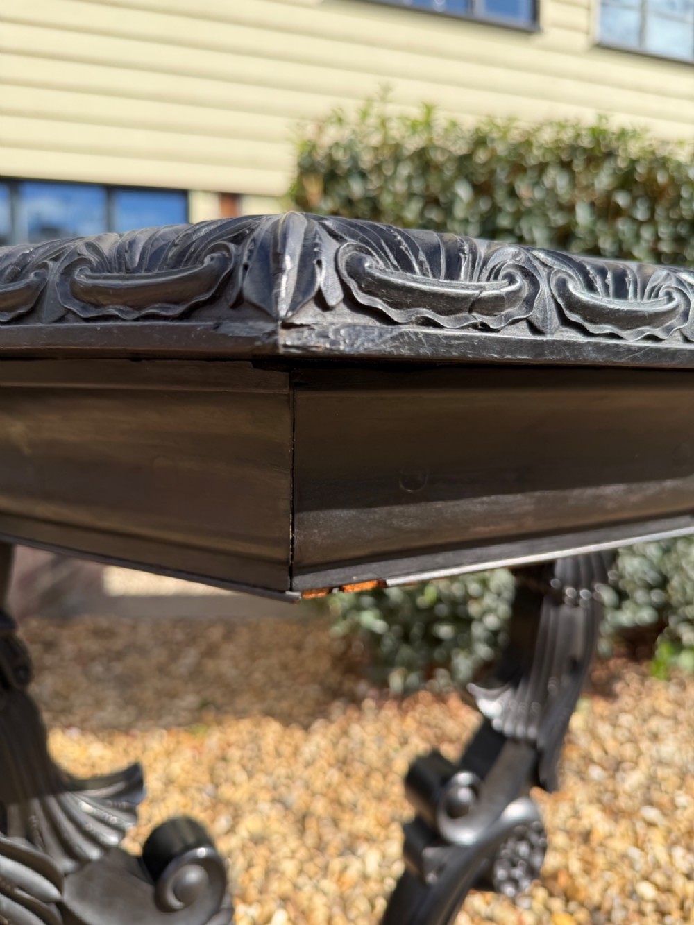 A pair of 19th-century Ceylonese ebony hexagonal occasional tables featuring inlaid geometric specimen wood tops and carved scroll legs. View V