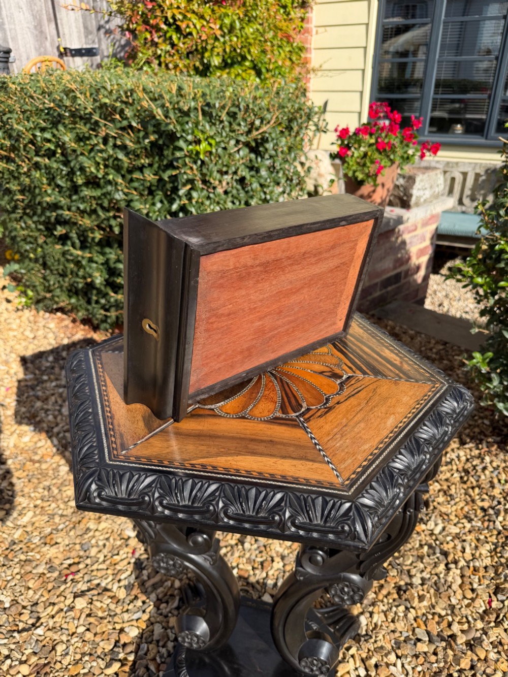 A pair of 19th-century Ceylonese ebony hexagonal occasional tables featuring inlaid geometric specimen wood tops and carved scroll legs. View VI