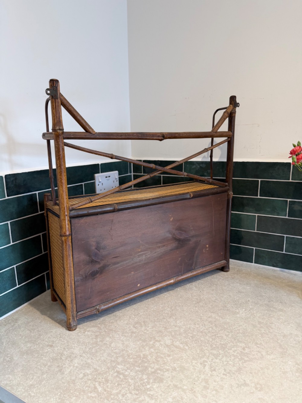 A Victorian bamboo and woven cane wall cupboard featuring two lower cabinet doors, an open upper display shelf, and an X-shaped cross support. View V