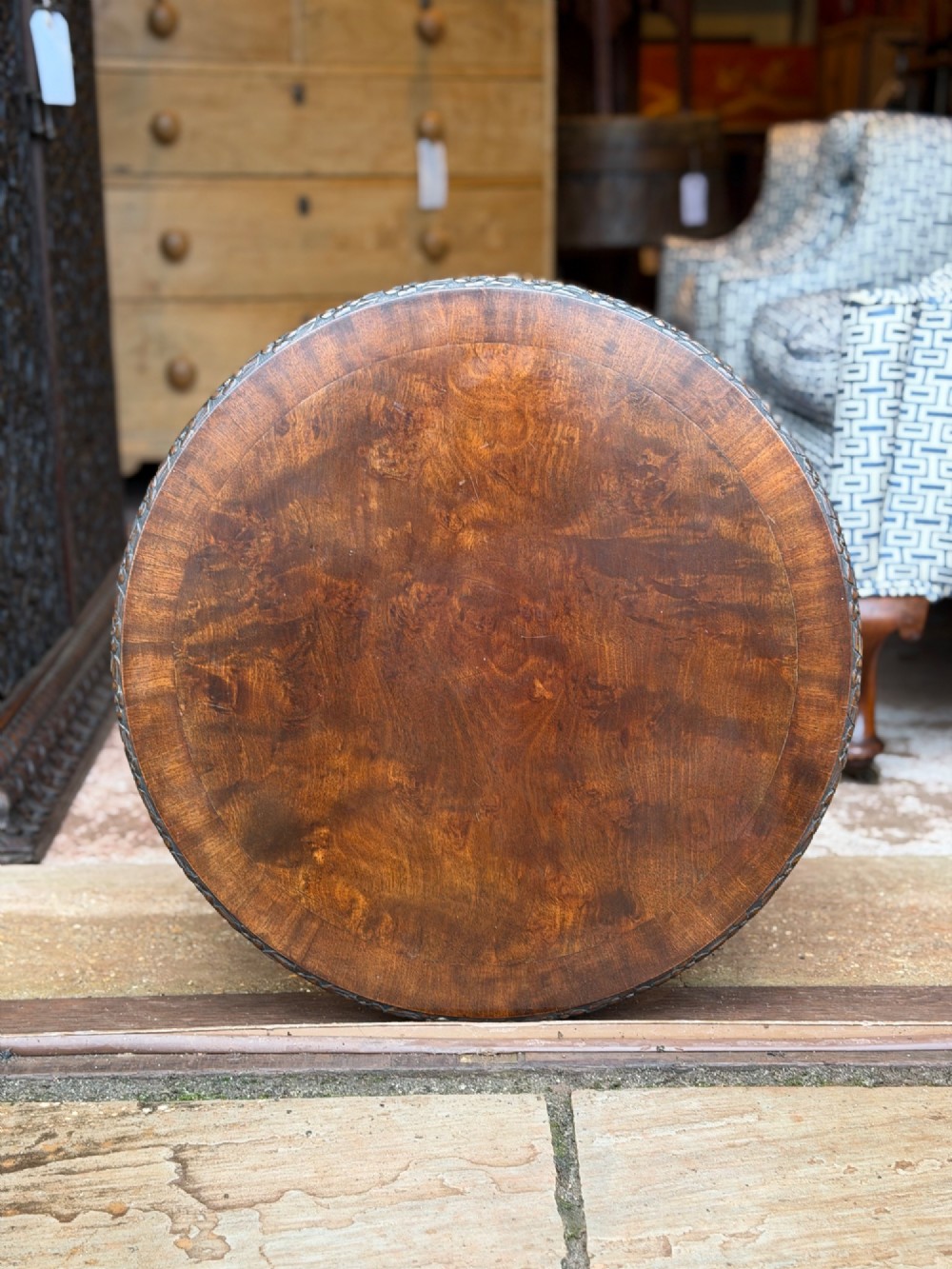 A circular mahogany occasional table featuring carved cabriole legs with pad feet and detailed knee carvings. View VI