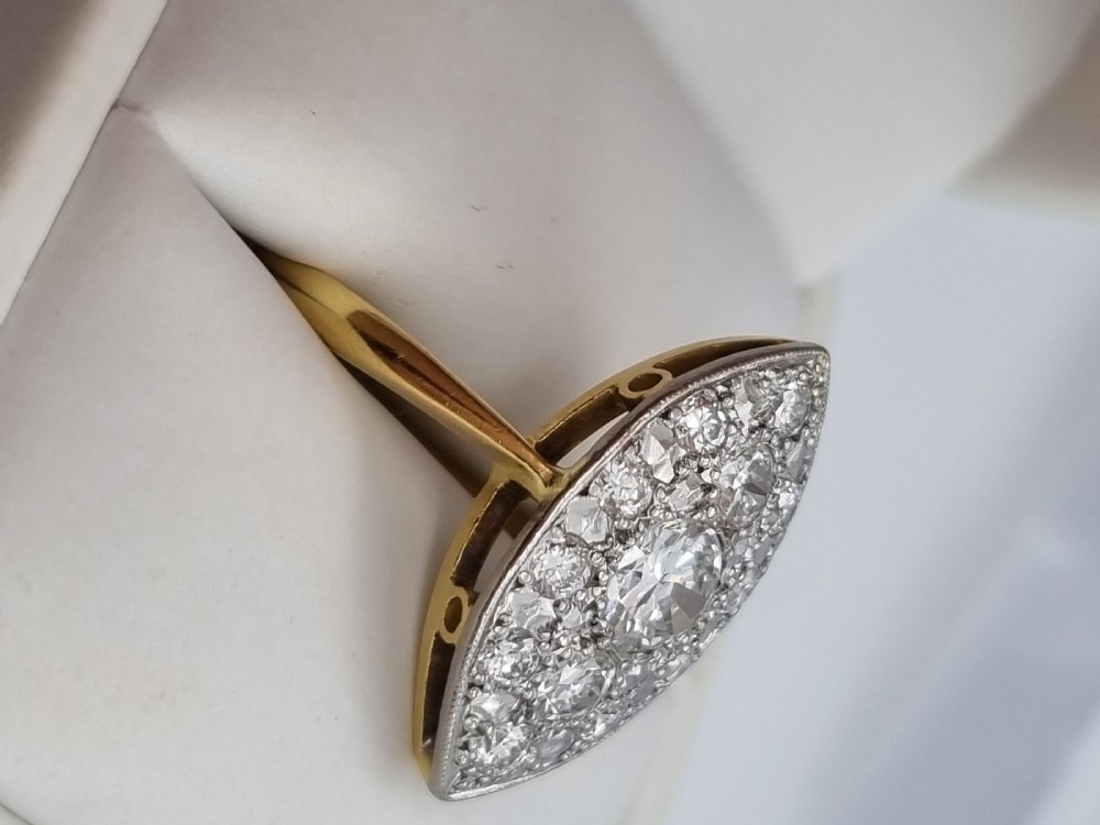 An antique navette-shaped cluster ring crafted in yellow gold with a platinum setting face set with multiple diamonds. View VI