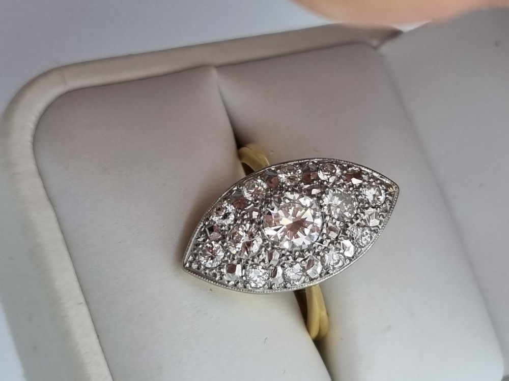 An antique navette-shaped cluster ring crafted in yellow gold with a platinum setting face set with multiple diamonds. View VII