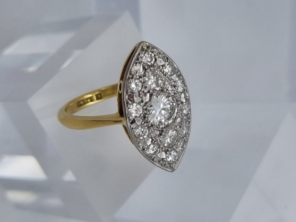 An antique navette-shaped cluster ring crafted in yellow gold with a platinum setting face set with multiple diamonds. View VIII