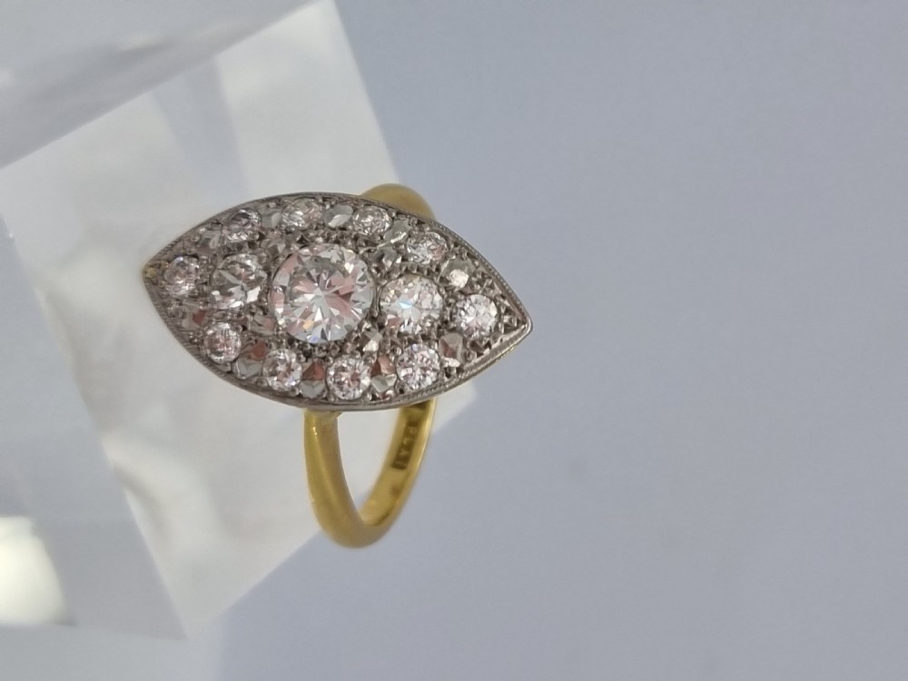 An antique navette-shaped cluster ring crafted in yellow gold with a platinum setting face set with multiple diamonds. View X