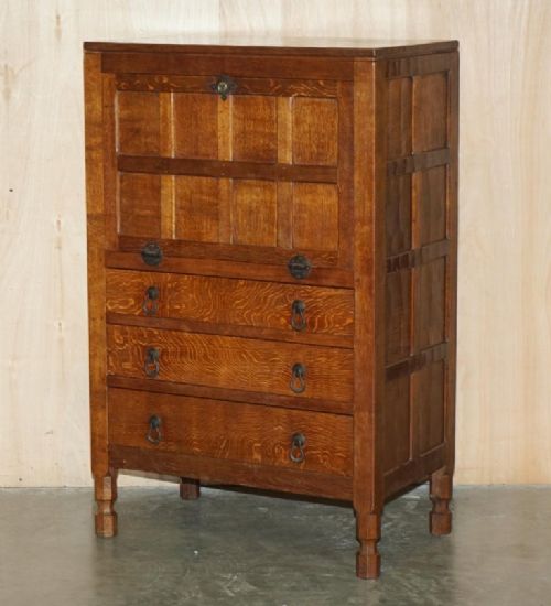 fig 2. A solid oak fall-front bureau desk featuring three lower drawers, panelled sides, and hand-forged wrought iron drop handles.