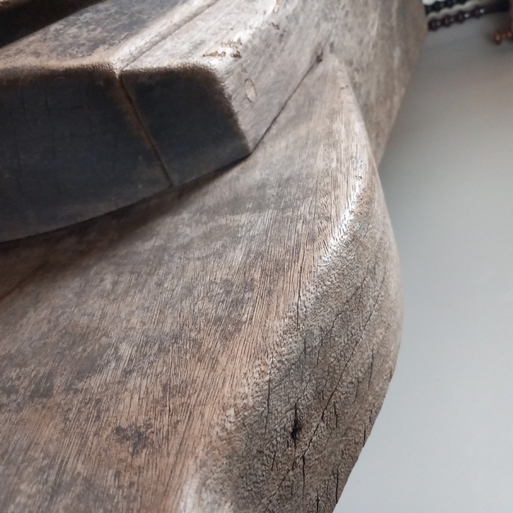 A carved solid oak bench shaped like a rhinoceros with a flat back seat and a dark timber finish. View VII