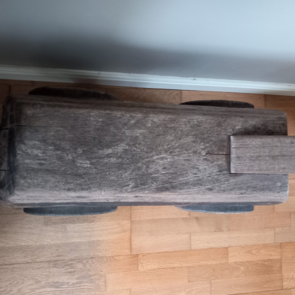 A carved solid oak bench shaped like a rhinoceros with a flat back seat and a dark timber finish. View VIII