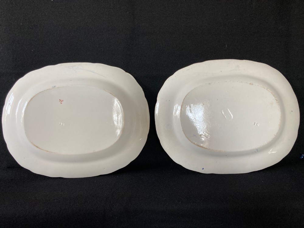 A pair of matching Victorian oval ironstone platters decorated with Imari style floral motifs in cobalt blue, terracotta, and gold detailing. View VII
