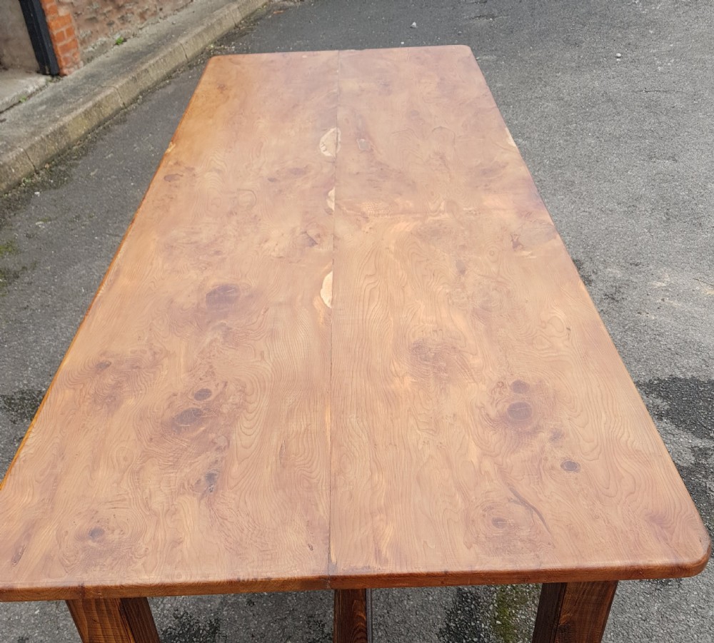 A rectangular yew wood farmhouse dining table featuring a polished timber tabletop, square legs, and an H-stretcher base. View IV