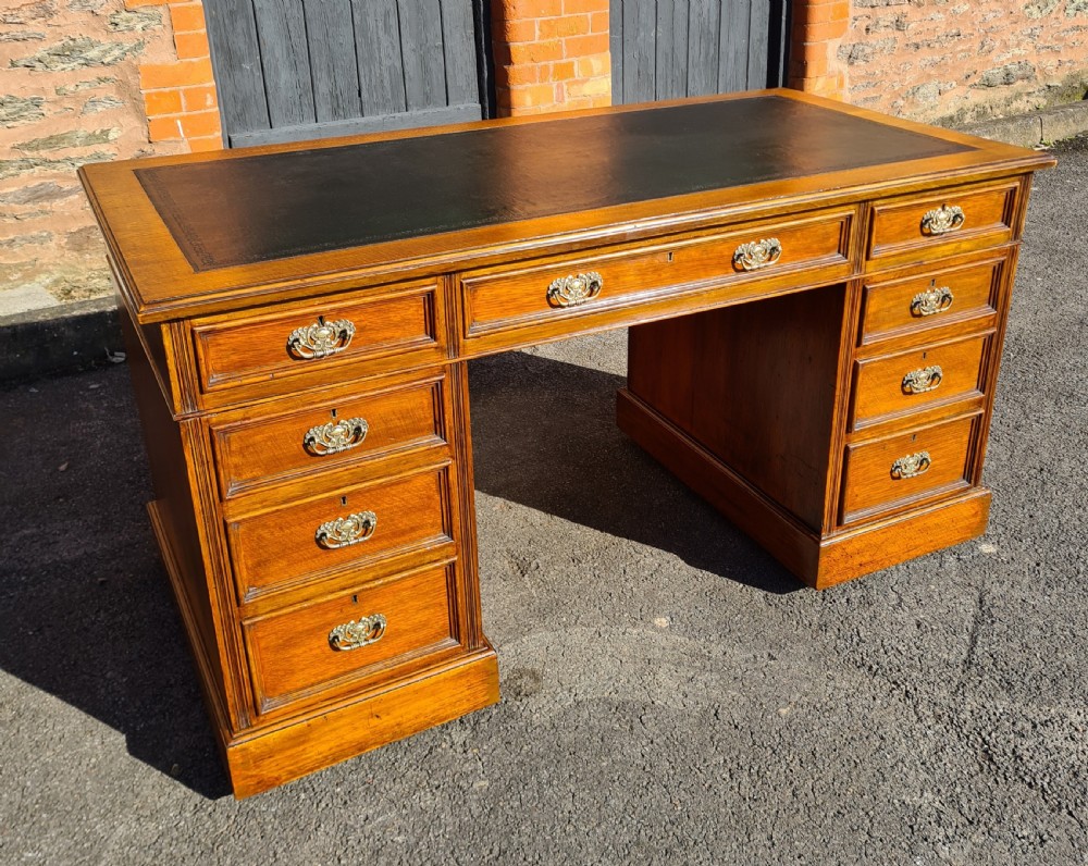 ANTIQUE VICTORIAN OAK NINE DRAWER DESK. 