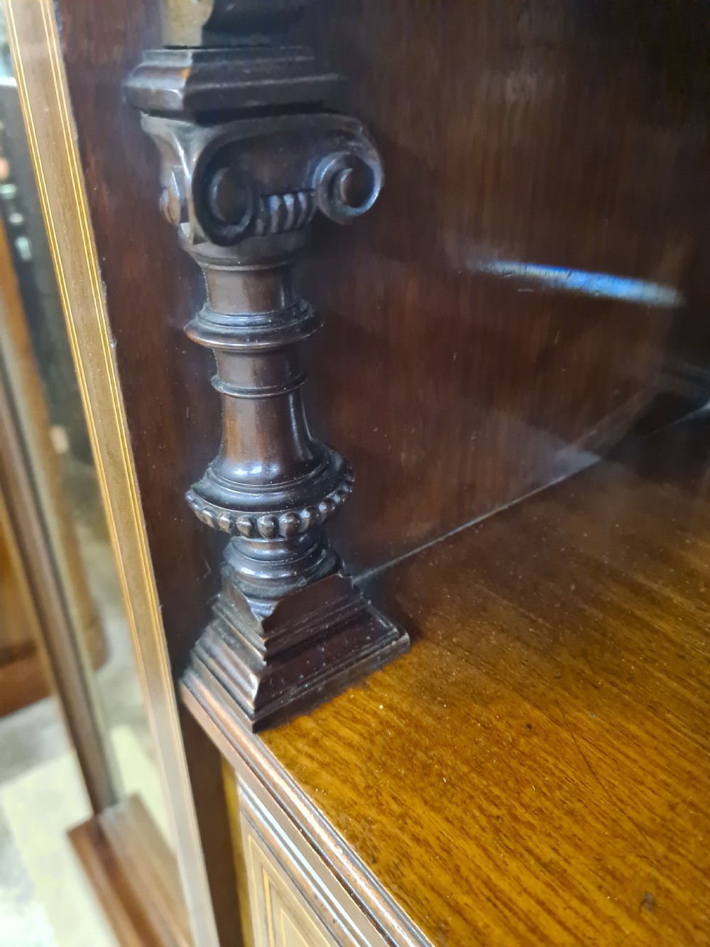 An Edwardian mahogany breakfront wardrobe with a central carved section, drawers, an open recessed shelf, and two full-length mirrored side doors. View XI