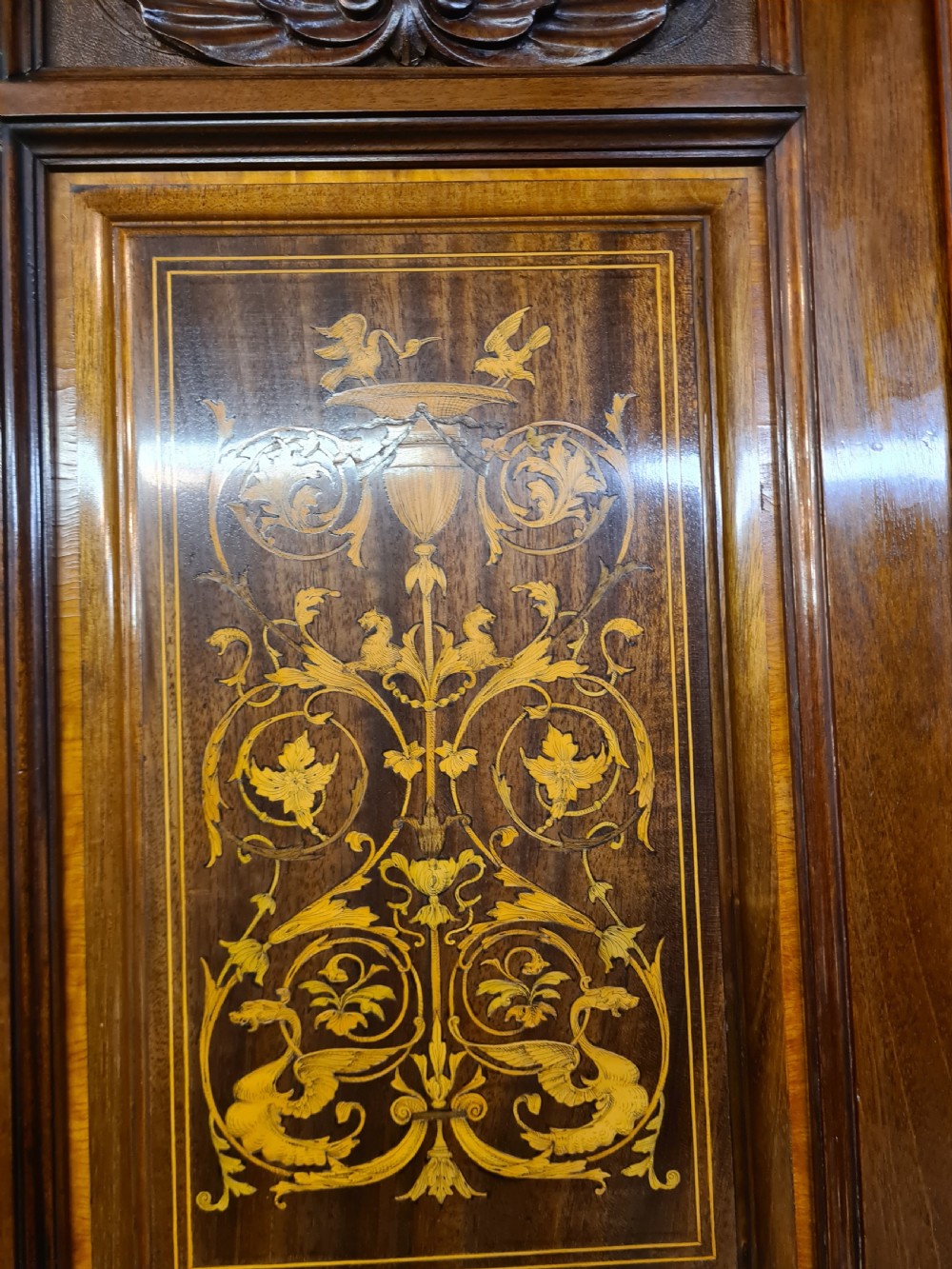 An Edwardian mahogany breakfront wardrobe with a central carved section, drawers, an open recessed shelf, and two full-length mirrored side doors. View XIV