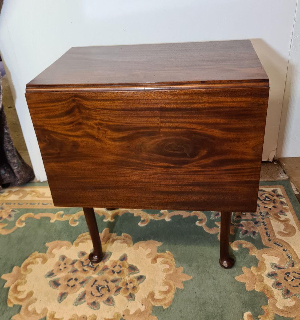 A Georgian mahogany side table featuring a polished rectangular top with a single hinged drop-leaf extension supported on turned legs. View II