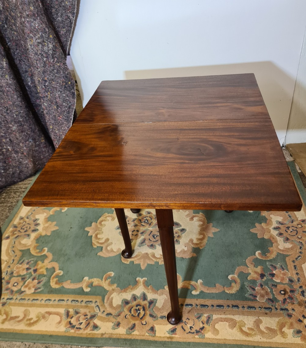 A Georgian mahogany side table featuring a polished rectangular top with a single hinged drop-leaf extension supported on turned legs. View III