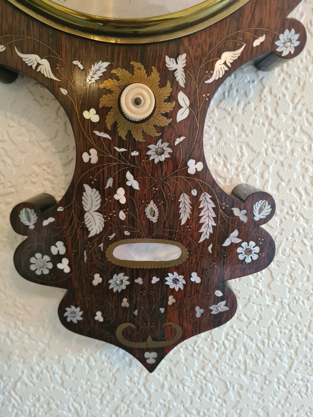 A 19th-century dark rosewood banjo barometer featuring intricate mother-of-pearl floral and bird inlays, an integrated thermometer, and a central round silvered dial. View VIII