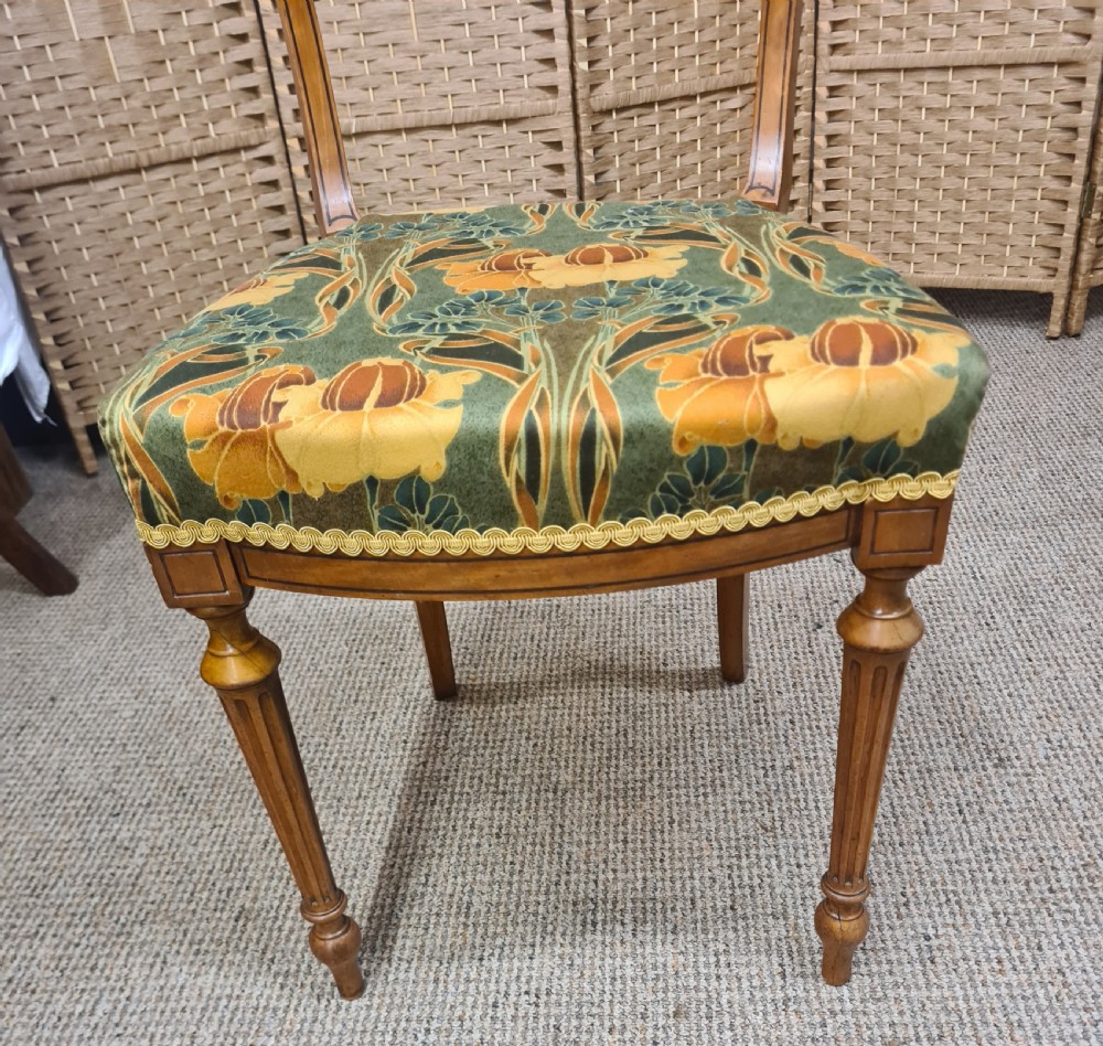 A pair of 19th-century satinwood side chairs featuring inlaid frames, open backs, turned fluted legs, and green floral pattern upholstery. View III