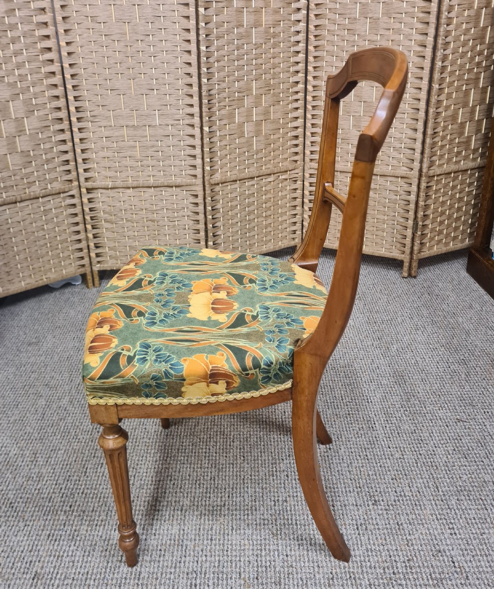 A pair of 19th-century satinwood side chairs featuring inlaid frames, open backs, turned fluted legs, and green floral pattern upholstery. View IV