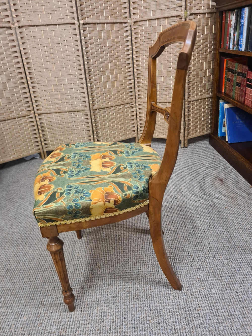 A pair of 19th-century satinwood side chairs featuring inlaid frames, open backs, turned fluted legs, and green floral pattern upholstery. View V