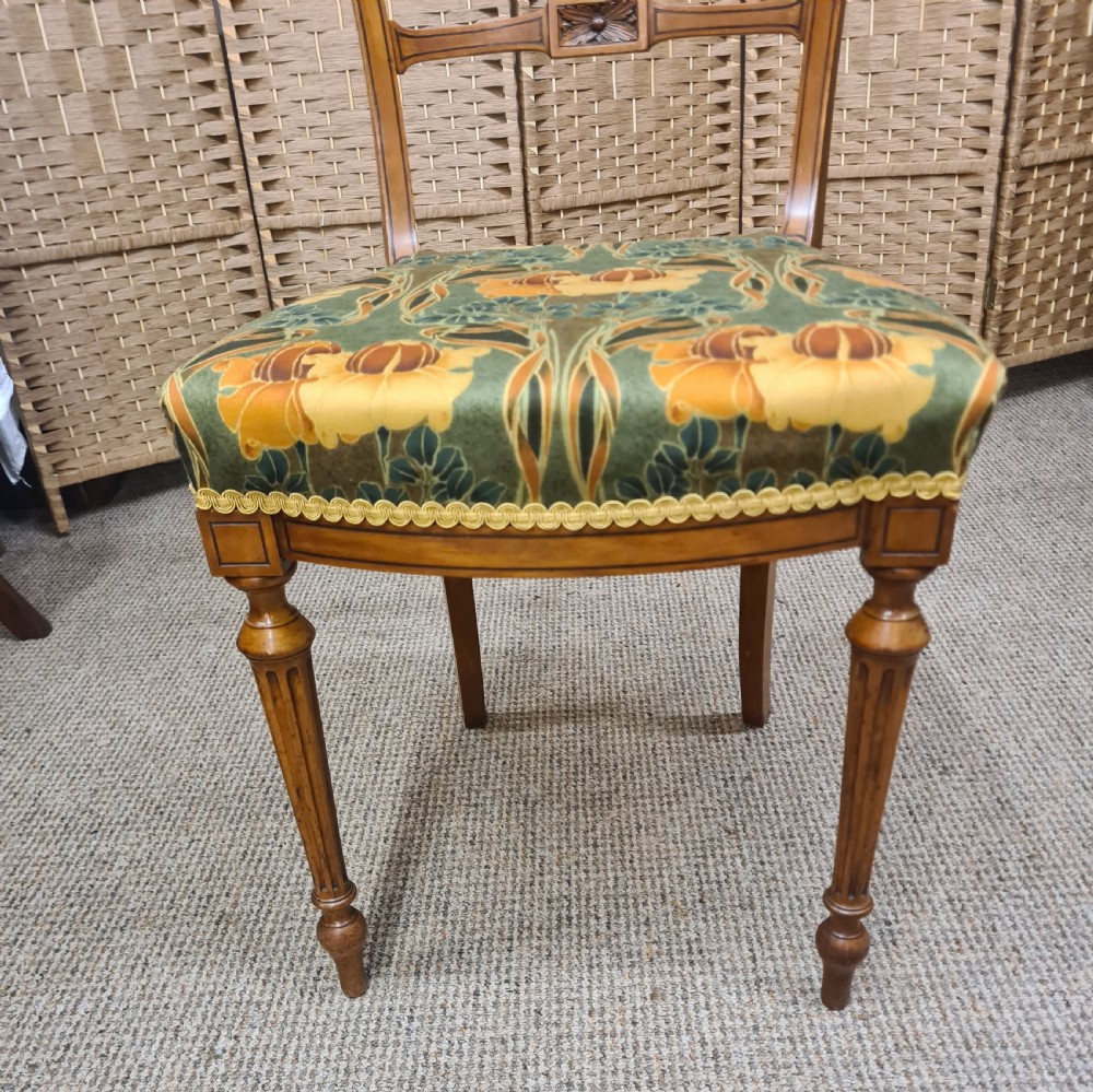 A pair of 19th-century satinwood side chairs featuring inlaid frames, open backs, turned fluted legs, and green floral pattern upholstery. View VI