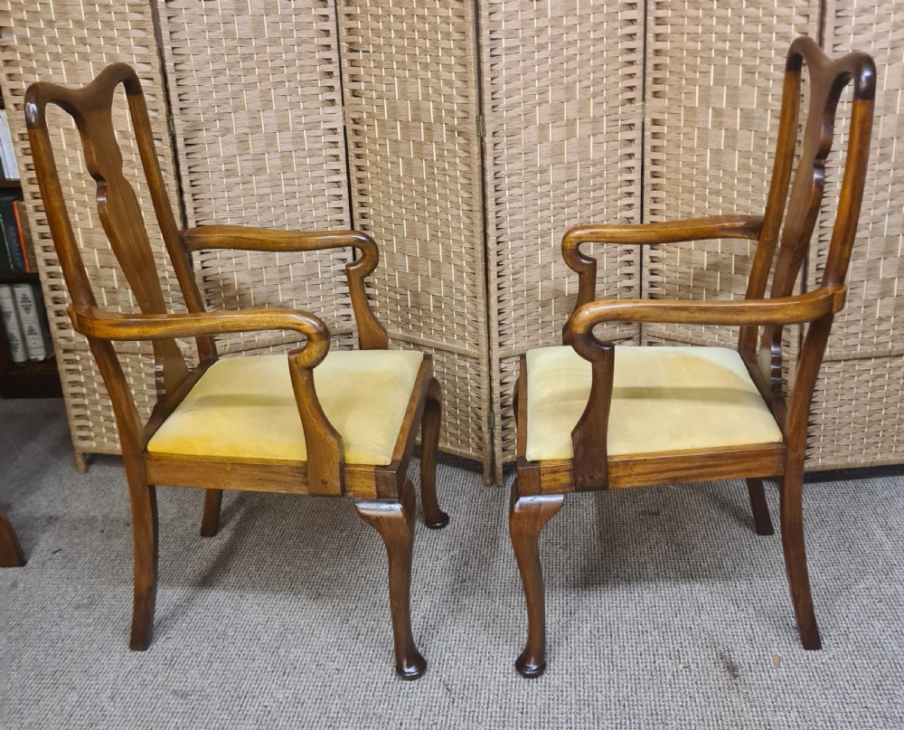 A pair of 1920s Queen Anne style walnut armchairs featuring vase-shaped splat backs, crook arms, cabriole legs with pad feet, and yellow velvet upholstered seats. View III