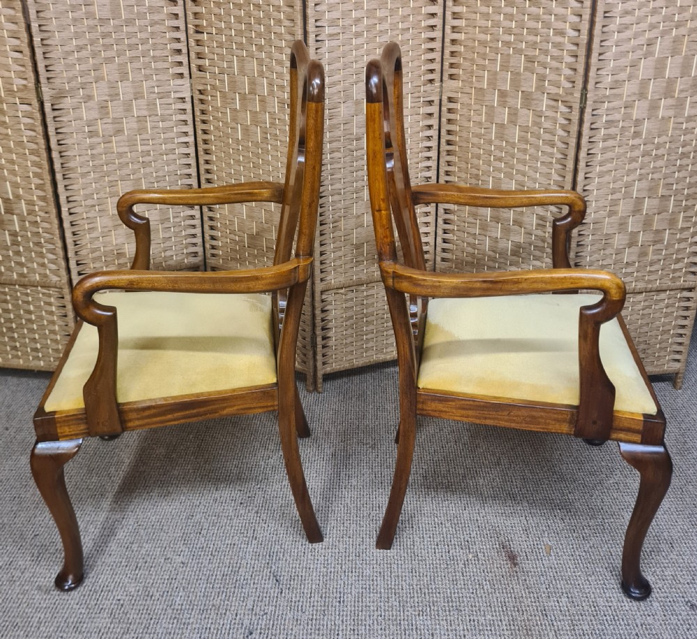 A pair of 1920s Queen Anne style walnut armchairs featuring vase-shaped splat backs, crook arms, cabriole legs with pad feet, and yellow velvet upholstered seats. View IV
