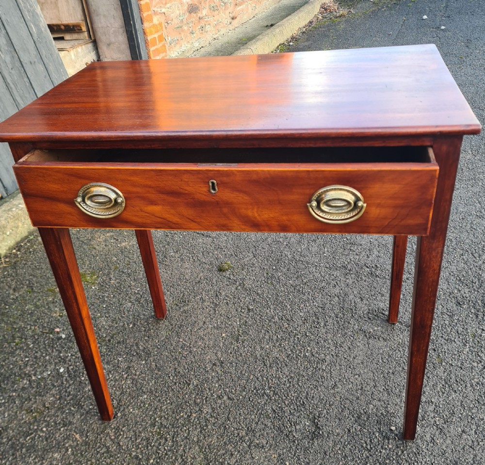 A Georgian mahogany side table featuring a full-width single drawer with brass oval handles and four square tapered legs. View II
