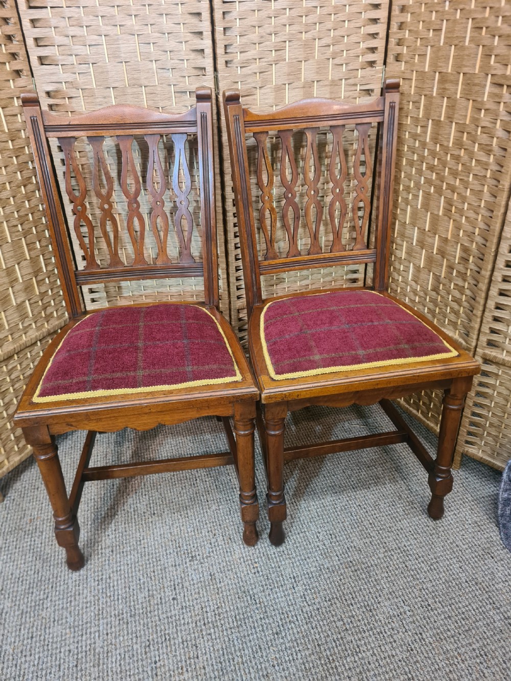 Set of six walnut Arts and Crafts dining chairs featuring pierced back slats, turned front legs, and red tartan upholstered seats with yellow trim. View III
