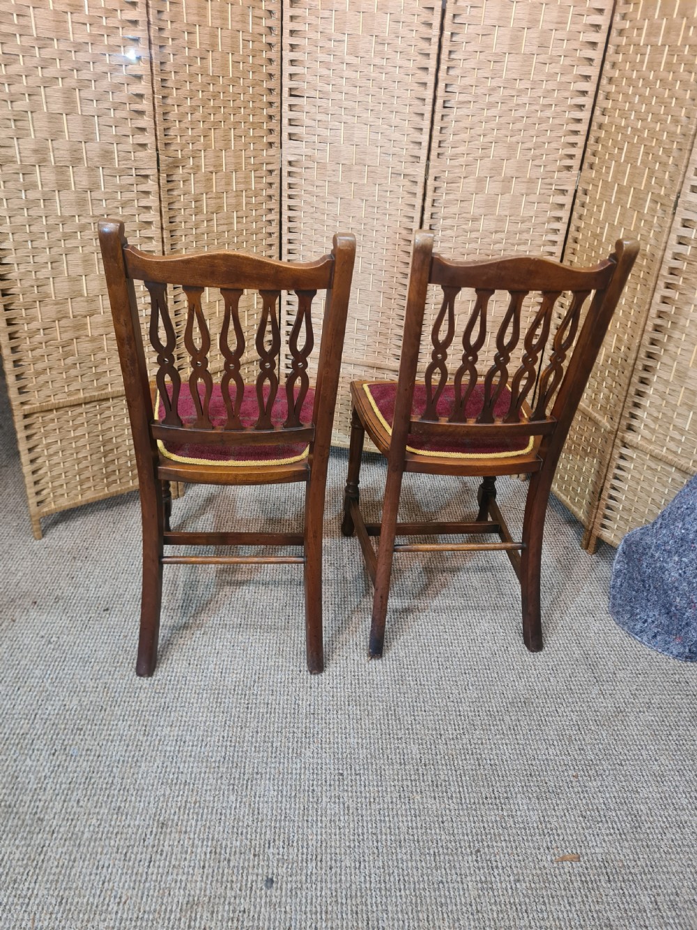 Set of six walnut Arts and Crafts dining chairs featuring pierced back slats, turned front legs, and red tartan upholstered seats with yellow trim. View V