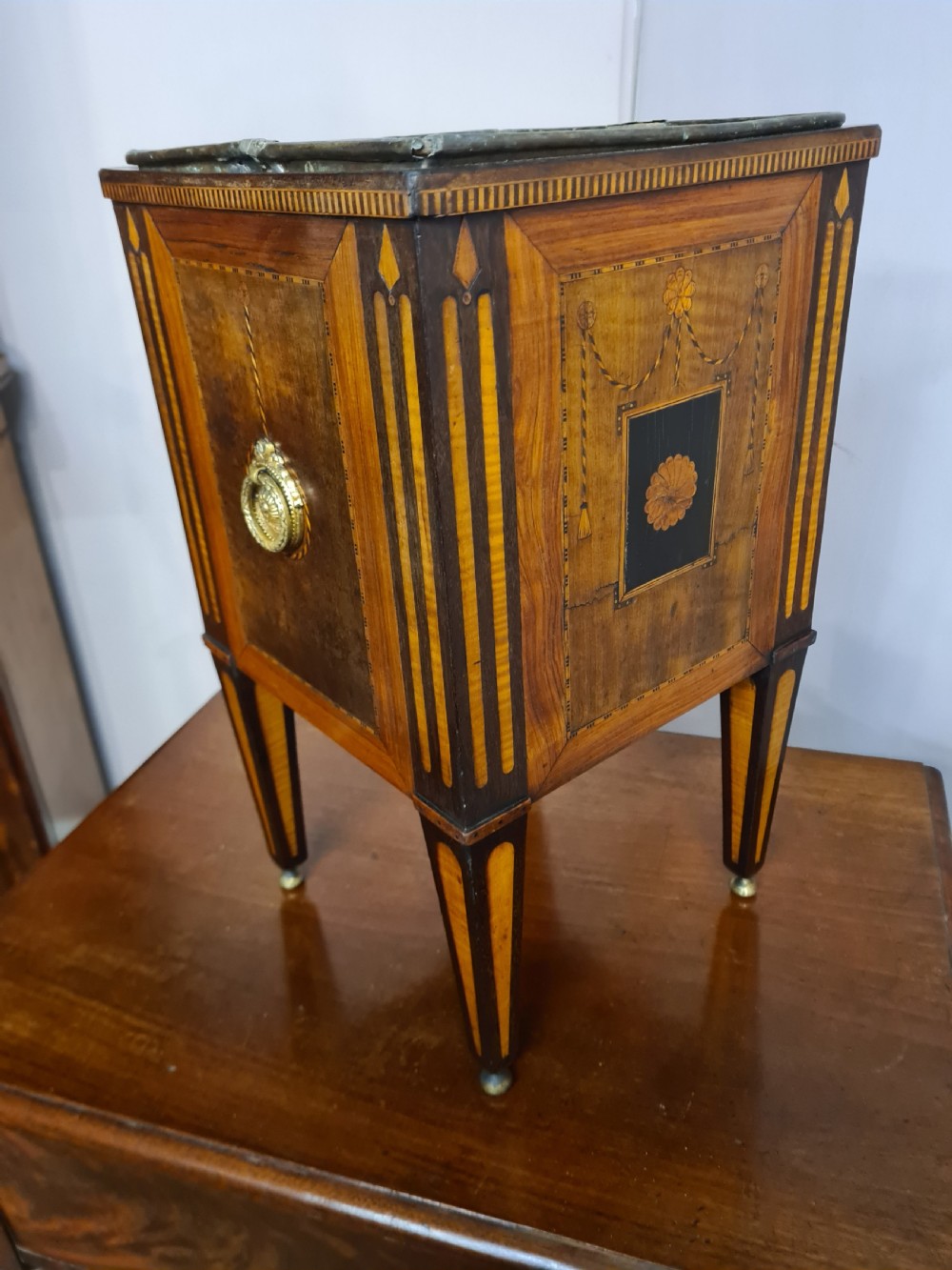A square Dutch Neoclassical satinwood and rosewood marquetry wine cooler with inlaid floral swags, brass ring handles, and square tapered legs. View II