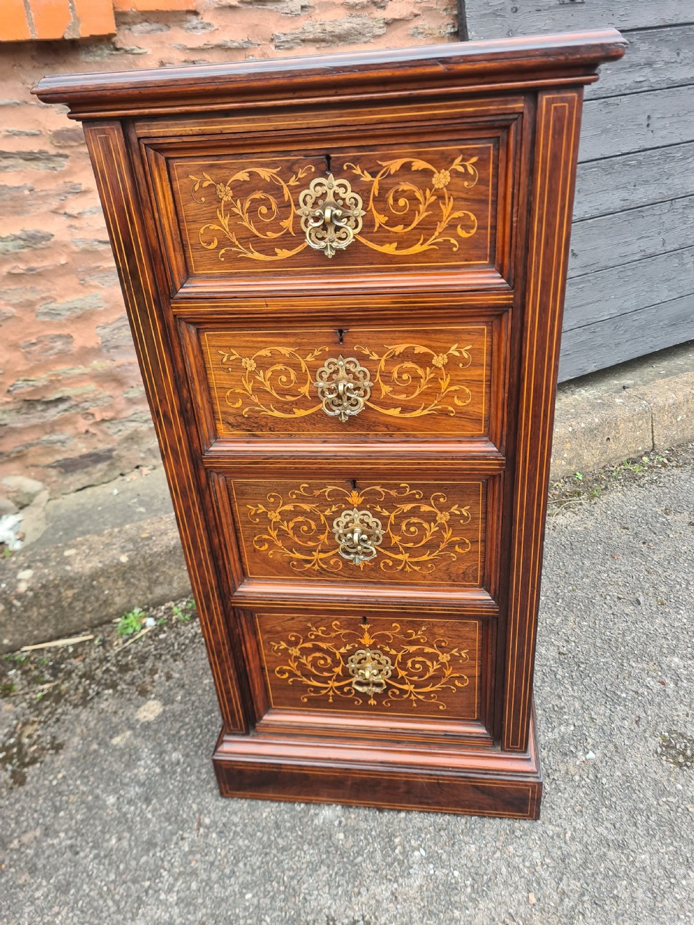 A pair of Victorian rosewood bedside cabinets featuring intricate floral marquetry inlays, four drawers each, and brass handles. View II